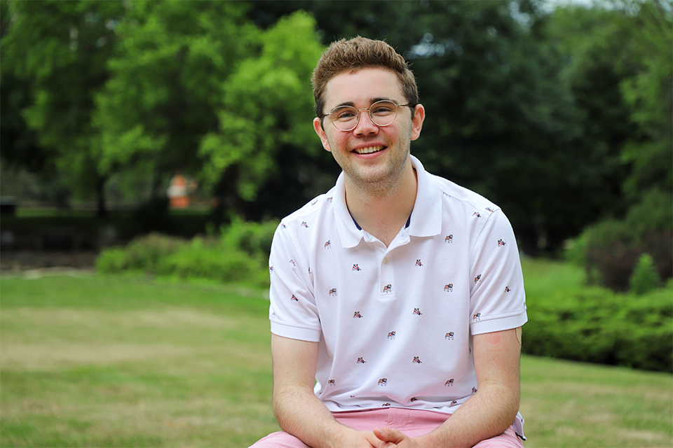 Henry Matus (CSB, '21) poses for a photo outside the Chaifetz School of Business on the campus of Saint Louis University.