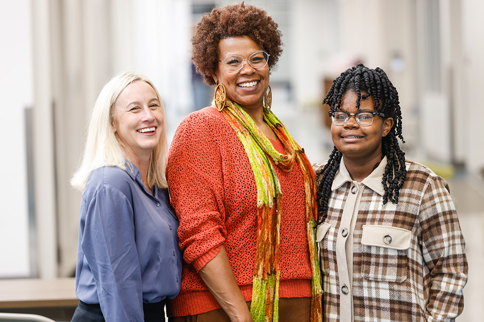 SLU Speech-Language Pathologist Christine Rose, left, with Jamie Saunders-Anglin, center, and her daughter Octavia at City Garden Montessori on Nov. 3, 2022. 