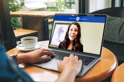 student on a laptop attending a video conference with a professor