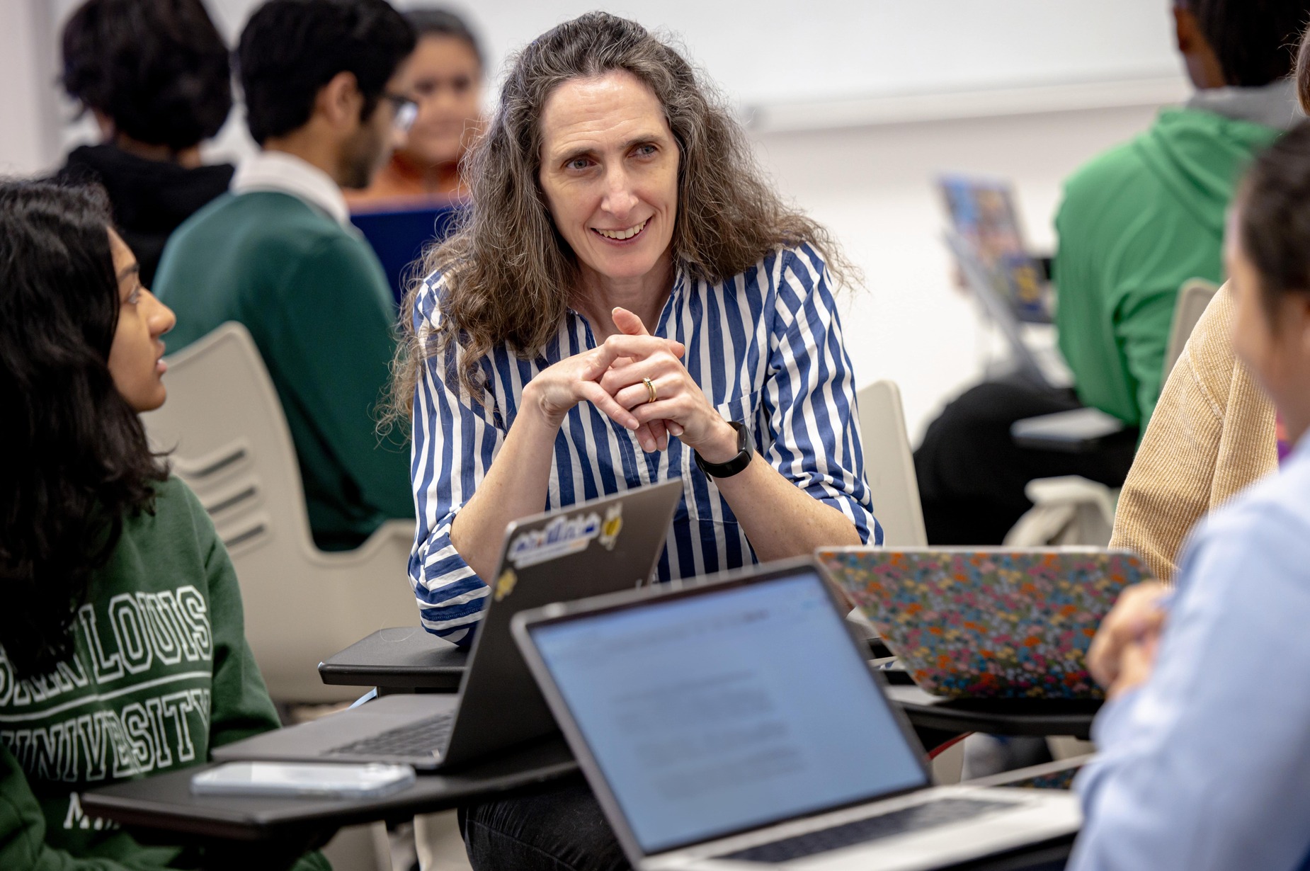 Faculty member working with students in a small group