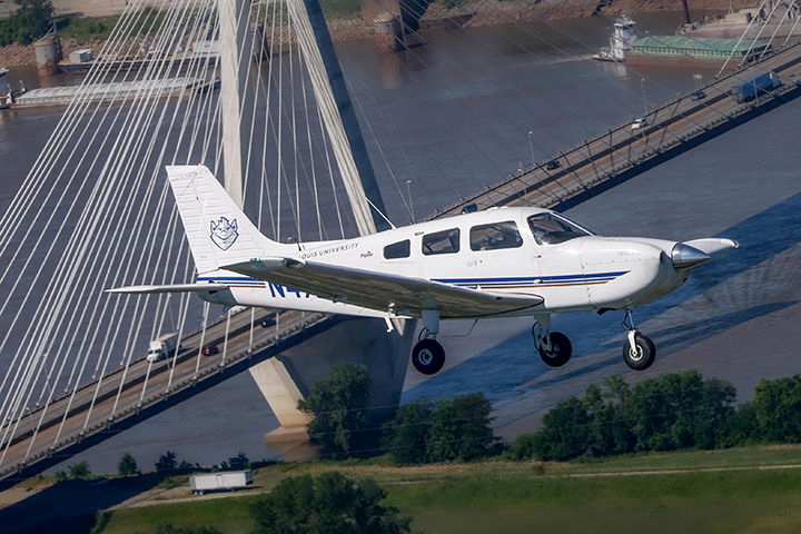 SLU plane flying over bridge in downtown St. Louis